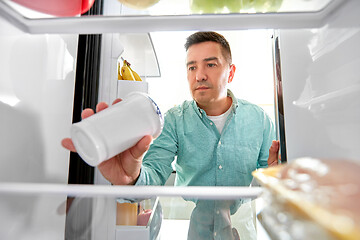 Image showing man taking food from fridge at kitchen