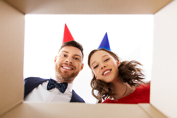 Image showing couple in party hats opening birthday gift box