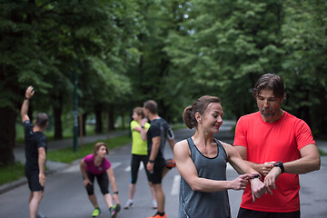 Image showing sporty couple using smart watches