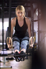 Image showing woman working out pull ups with gymnastic rings