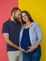 Image showing pregnant couple  isolated over colorful background