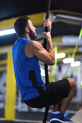 Image showing man doing rope climbing