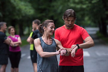 Image showing sporty couple using smart watches