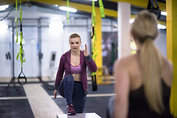 Image showing athletes working out  jumping on fit box