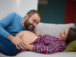 Image showing future dad listening the belly of his pregnant wife