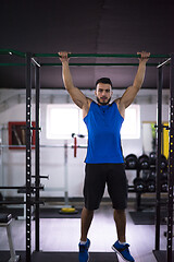 Image showing man doing pull ups on the horizontal bar