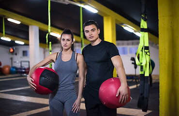 Image showing young athletes couple working out with medical ball