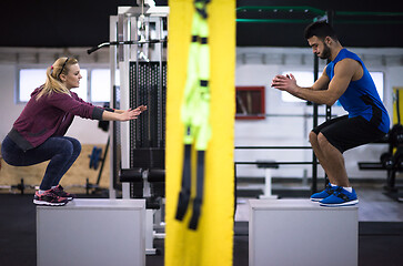 Image showing athletes working out  jumping on fit box