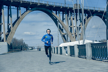 Image showing Man running on city background at morning.