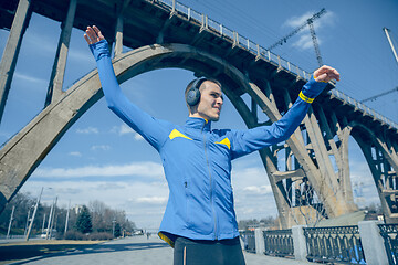 Image showing Man running on city background at morning