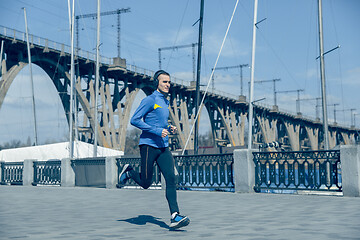 Image showing Man running on city background at morning.