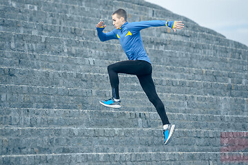 Image showing Man running on city background at morning.