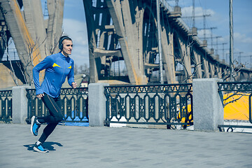 Image showing Man running on city background at morning.