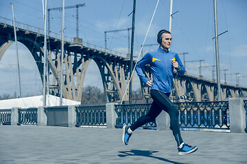 Image showing Man running on city background at morning.