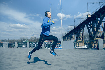 Image showing Man running on city background at morning.