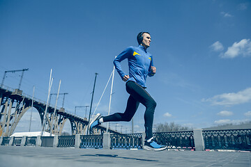 Image showing Man running on city background at morning.