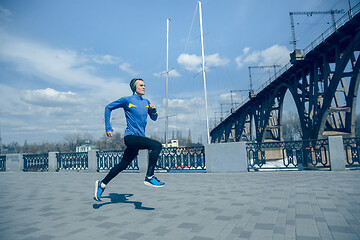 Image showing Man running on city background at morning.