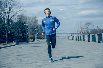 Image showing Man running on city background at morning.