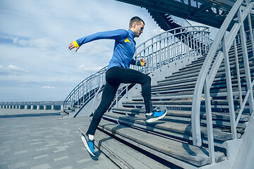 Image showing Man running on city background at morning.