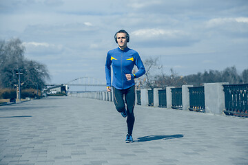 Image showing Man running on city background at morning.