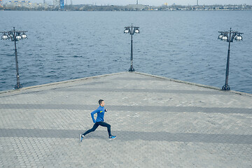 Image showing Man running on city background at morning.