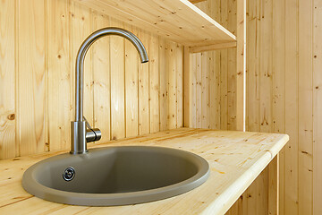 Image showing Kitchen set in a country house, natural wood worktop