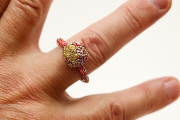 Image showing unpretentious finger ring made of recycled materials on the fing