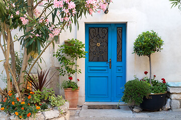 Image showing Beutiful vintage courtyard with lush greenery and marine blue wooden door in old Mediterranean costal town, Croatia