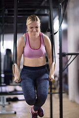 Image showing woman working out pull ups with gymnastic rings