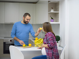 Image showing couple cooking food fruit lemon juice at kitchen