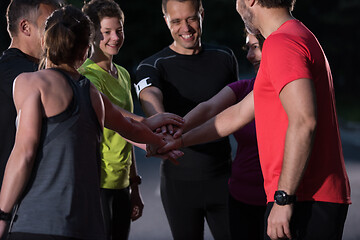 Image showing runners giving high five to each other