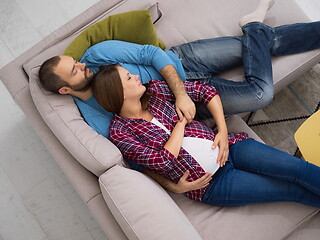 Image showing pregnant couple relaxing on sofa