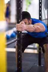 Image showing man doing pull ups on the vertical bar