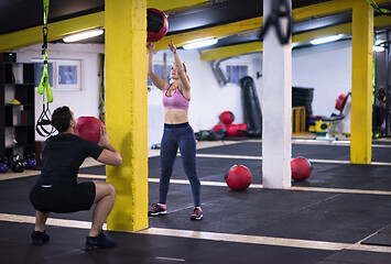 Image showing young athletes couple working out with medical ball