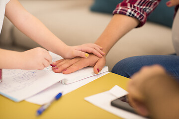 Image showing daughter painting nails to her pregnant mom