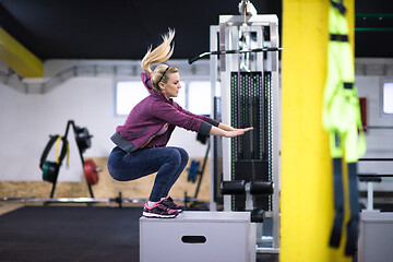 Image showing woman working out  jumping on fit box