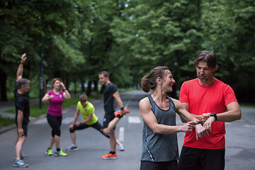 Image showing sporty couple using smart watches