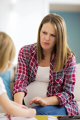 Image showing daughter painting nails to her pregnant mom