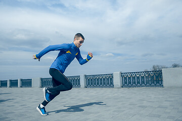 Image showing Man running on city background at morning.