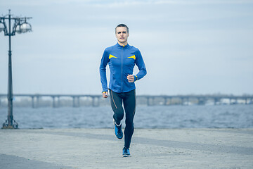 Image showing Man running on city background at morning.