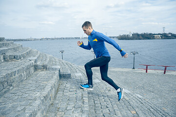 Image showing Man running on city background at morning.