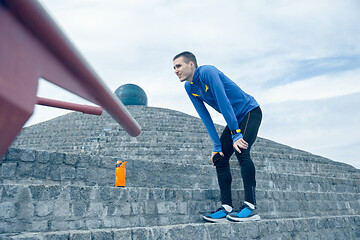 Image showing Man on city background at morning. Healthy lifestyle concept.