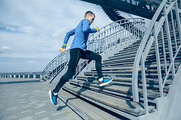 Image showing Man running on city background at morning.