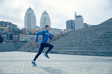 Image showing Man running on city background at morning.