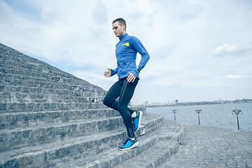 Image showing Man running on city background at morning.