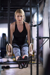 Image showing woman working out pull ups with gymnastic rings