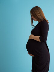 Image showing Portrait of pregnant woman over blue background