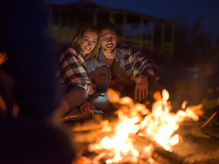 Image showing Couple enjoying with friends at night on the beach