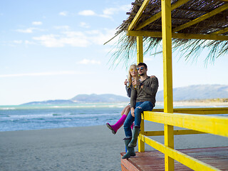 Image showing young couple drinking beer together at the beach