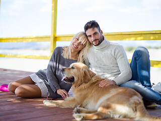 Image showing Couple with dog enjoying time on beach